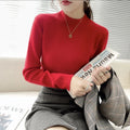 Slim fit apricot coloured viscose knitted long sleeve pullover shirt on a hanger.