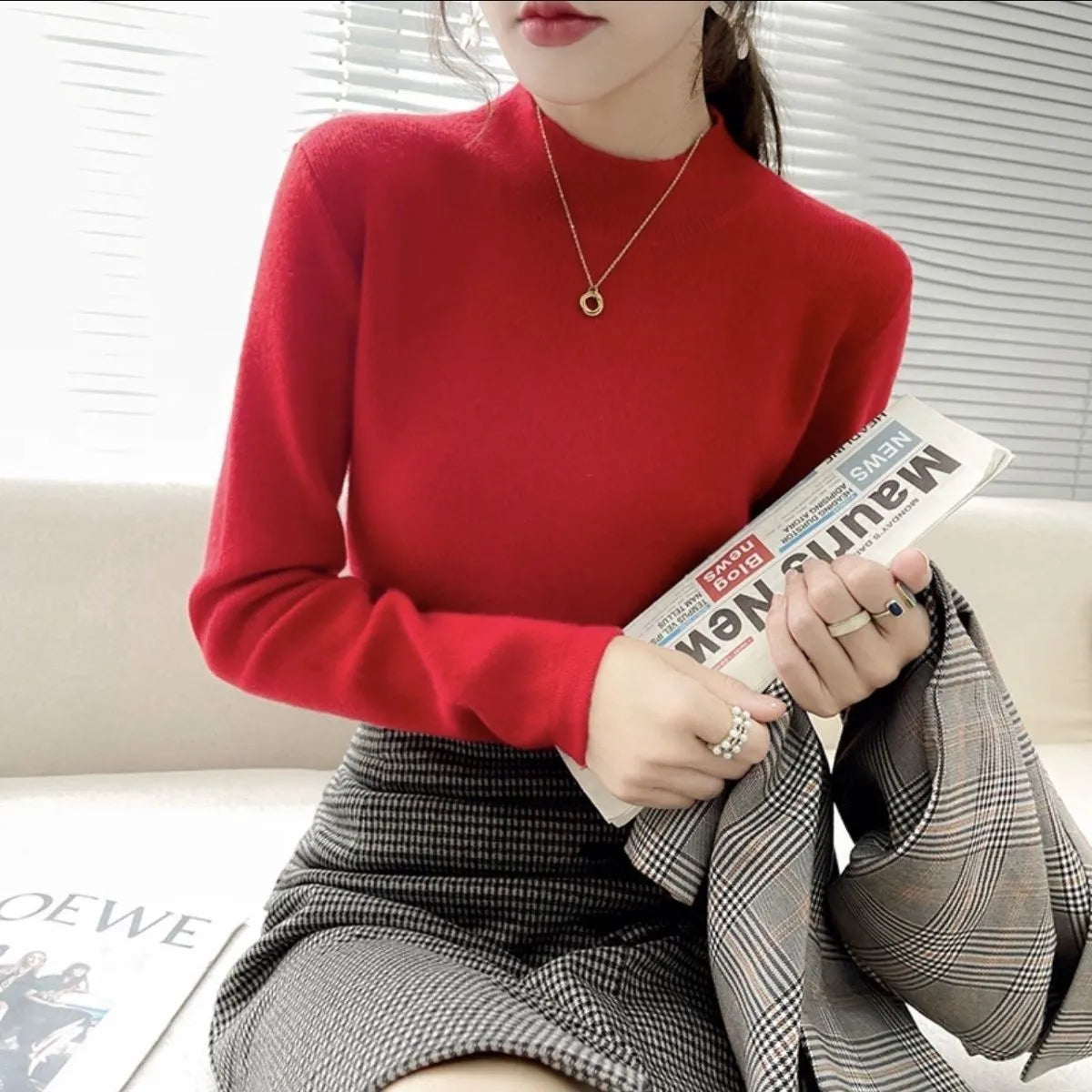 Slim fit apricot coloured viscose knitted long sleeve pullover shirt on a hanger.