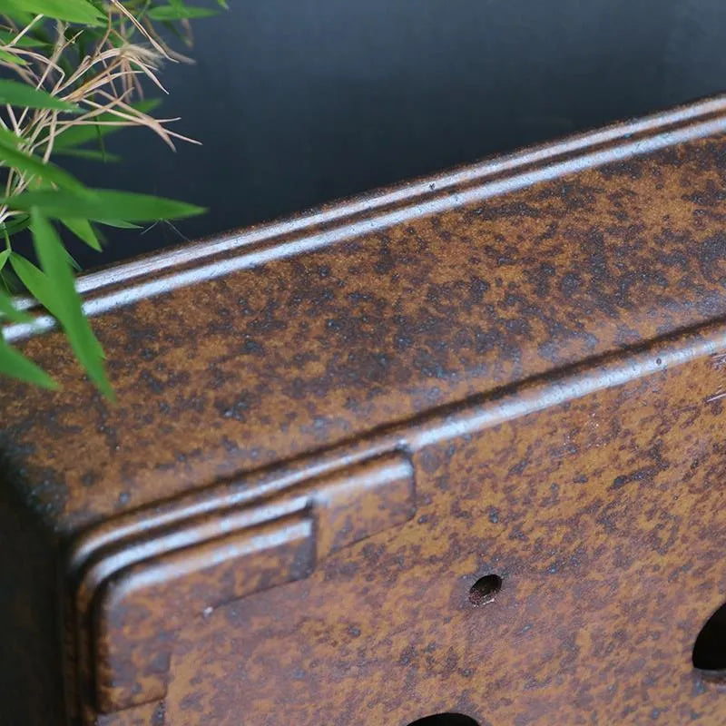 Rectangular purple sand bonsai pot on floor, showing simple five-line basin design.