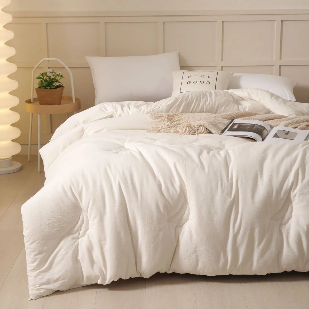 Soybean fibre quilt with pure cotton twill cover in grey, shown on a bed.