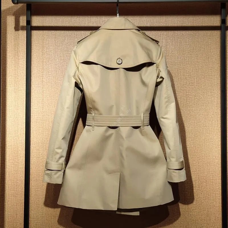 Khaki coloured women's double-breasted trench coat with flight sleeves on a hanger.