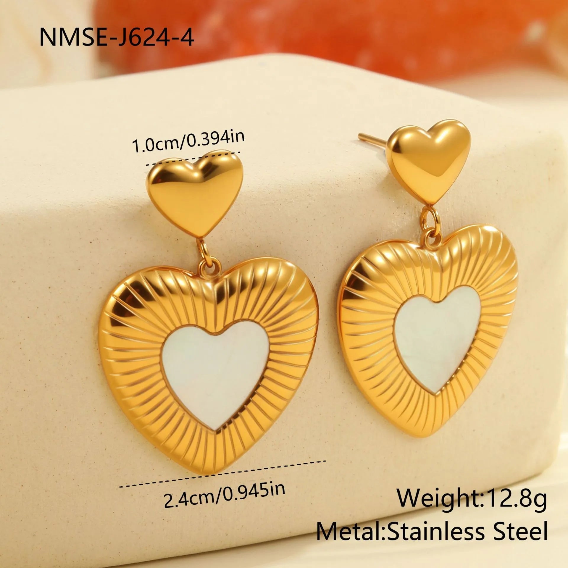 Gold electroplated heart-shaped stainless steel earrings with white fritillary detail