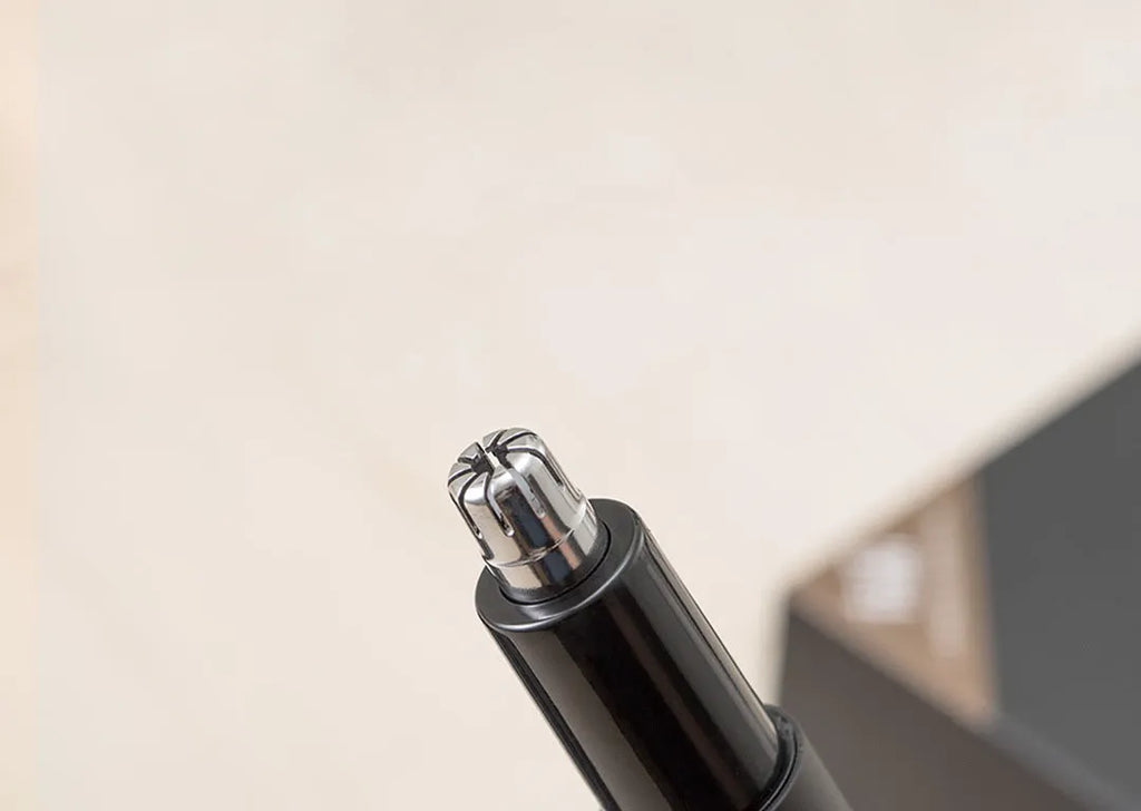 White HN3 electric nose hair trimmer on table with 420J2 steel cutter head