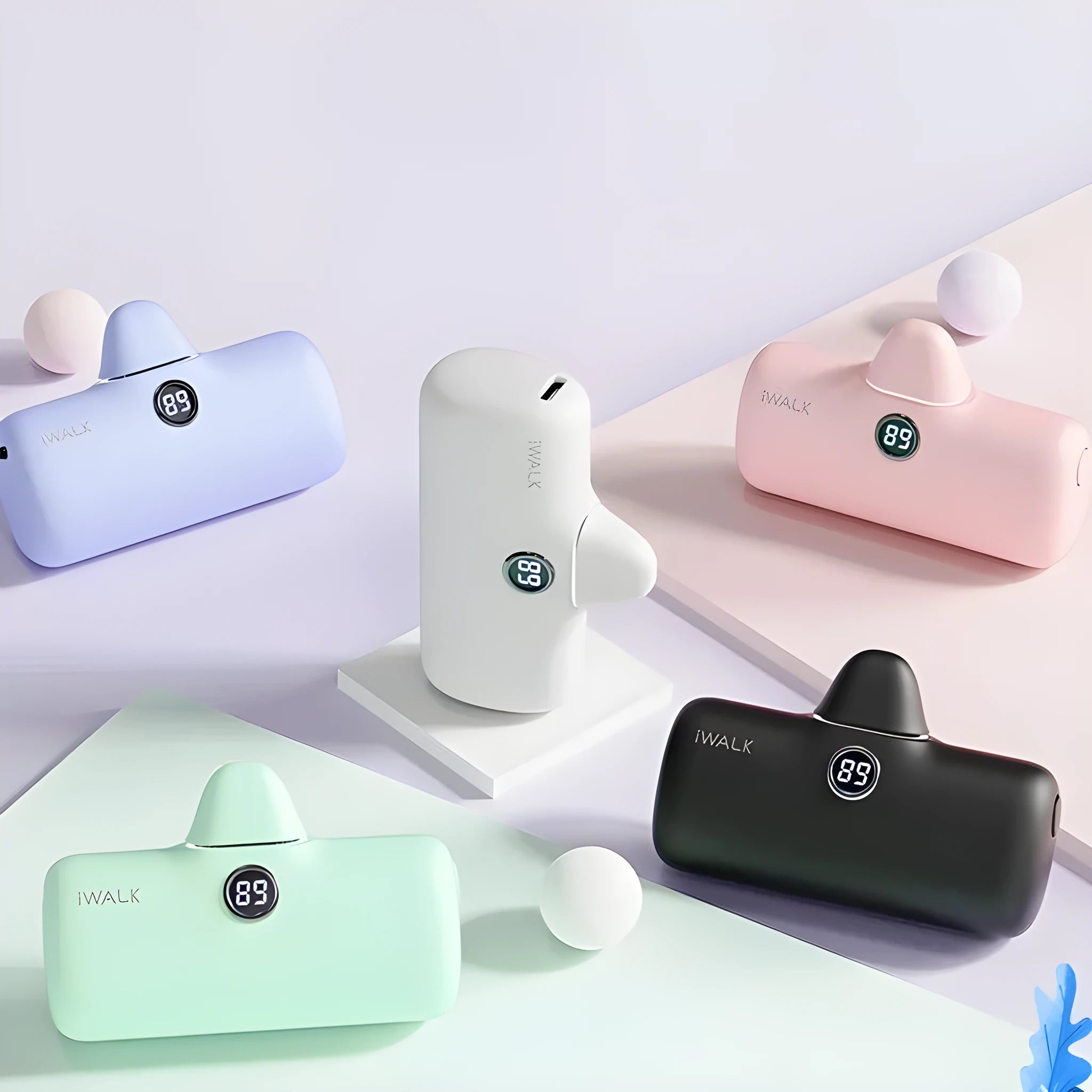 Small white cylindrical lipstick-shaped power bank showing digital battery percentage display on its side.