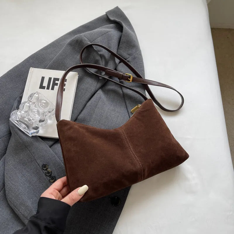 Retro suede underarm bag in black with bucket shape, sandwich pocket, and visible sewing detail