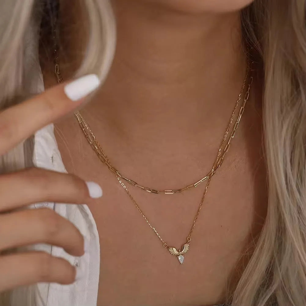 Women's silver eagle pendant necklace on an O-ring chain in white gold or yellow gold colour.