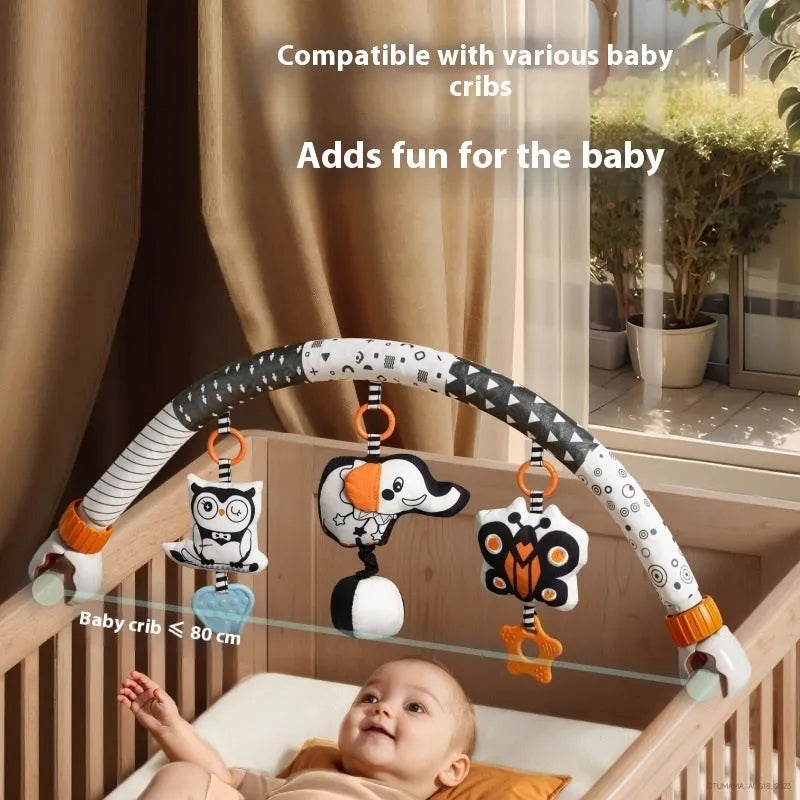 Baby lathe clip hanging plush toy in black and white, with pull vibration teether and BB call, attached to a cot side