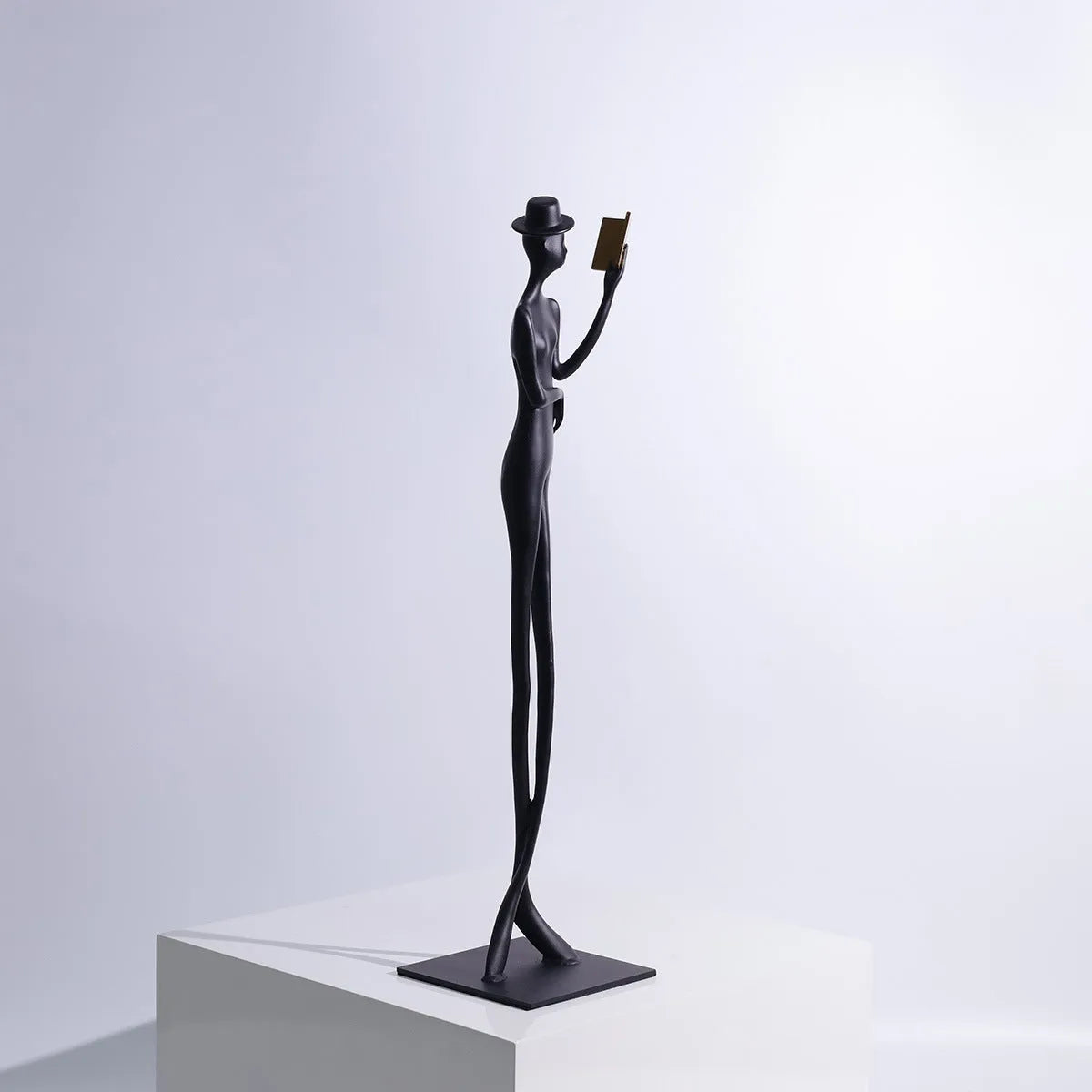 Black aluminium reading woman desktop sculpture with modern geometric design