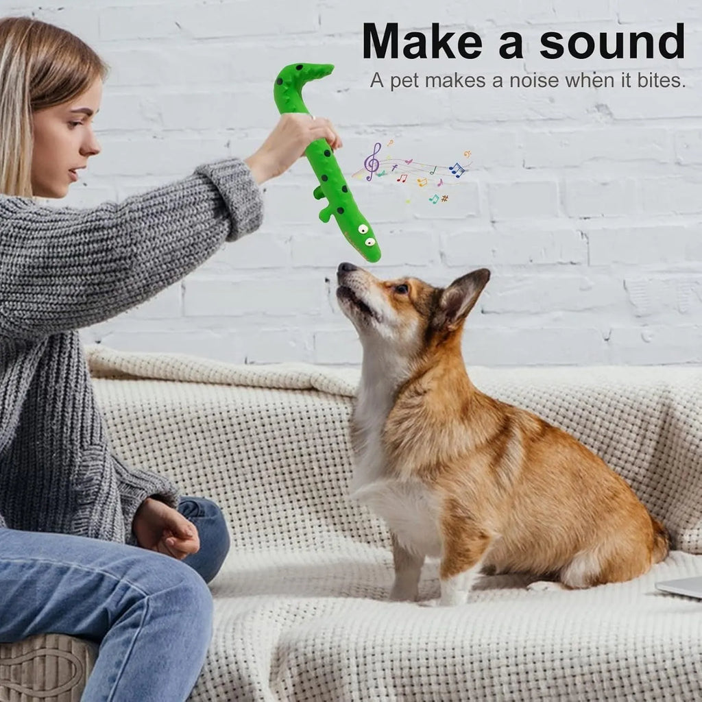Green cartoon lizard-shaped dog chew toy with squeaker on a white background.