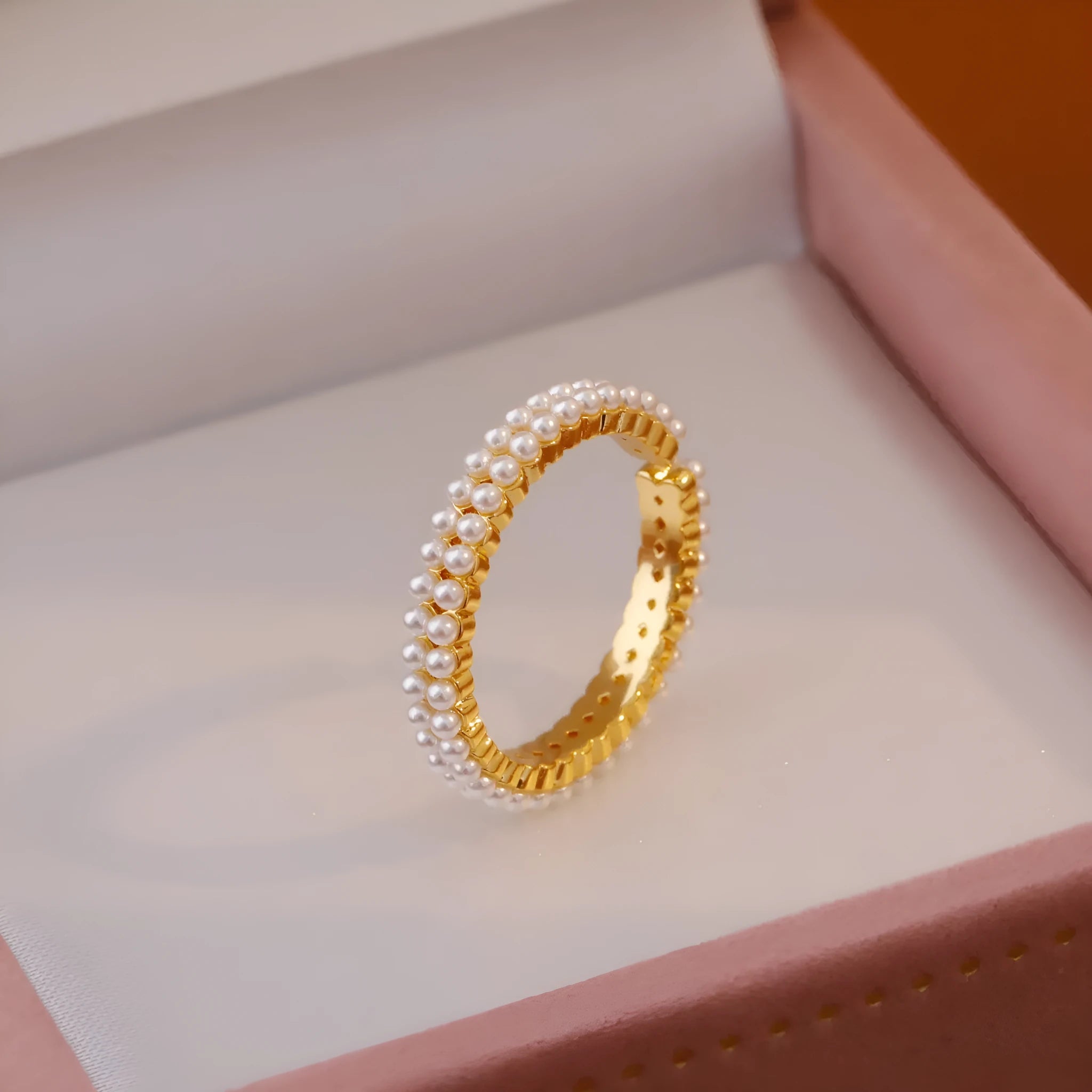 Gold electroplated open mouth pearl ring with geometry design on a copper base.