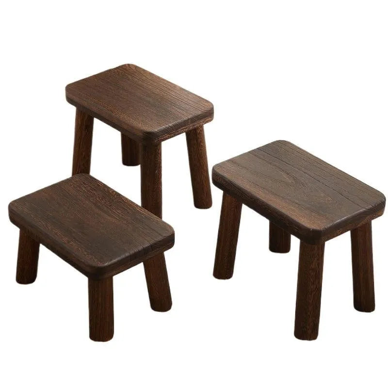 Solid wood household stool with distressed finish, shown as a changing stool or footrest.