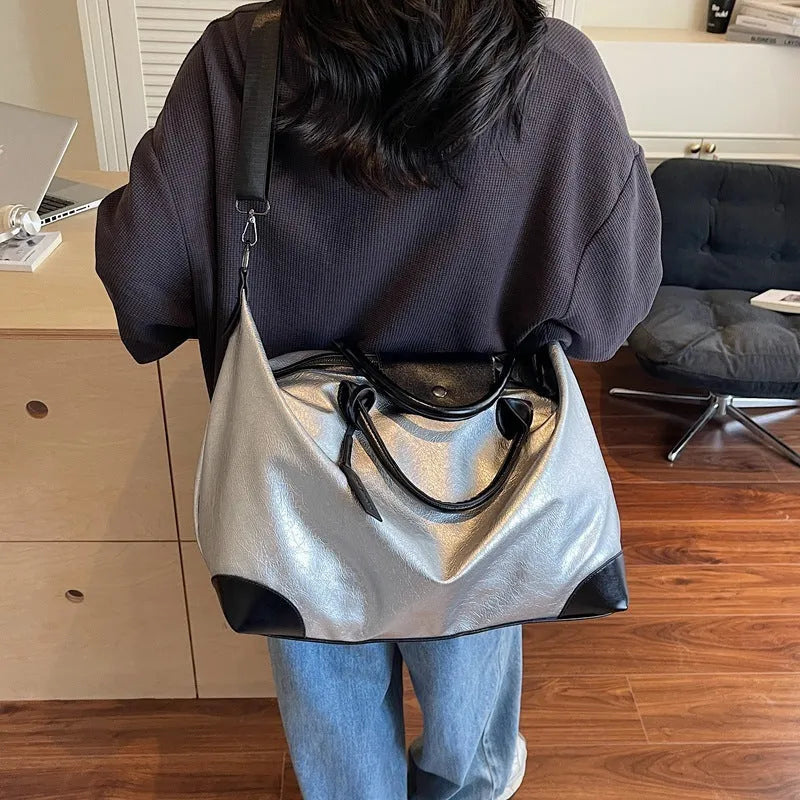 Women's hand-carry travel bag with 36-55L capacity in black or silver colour