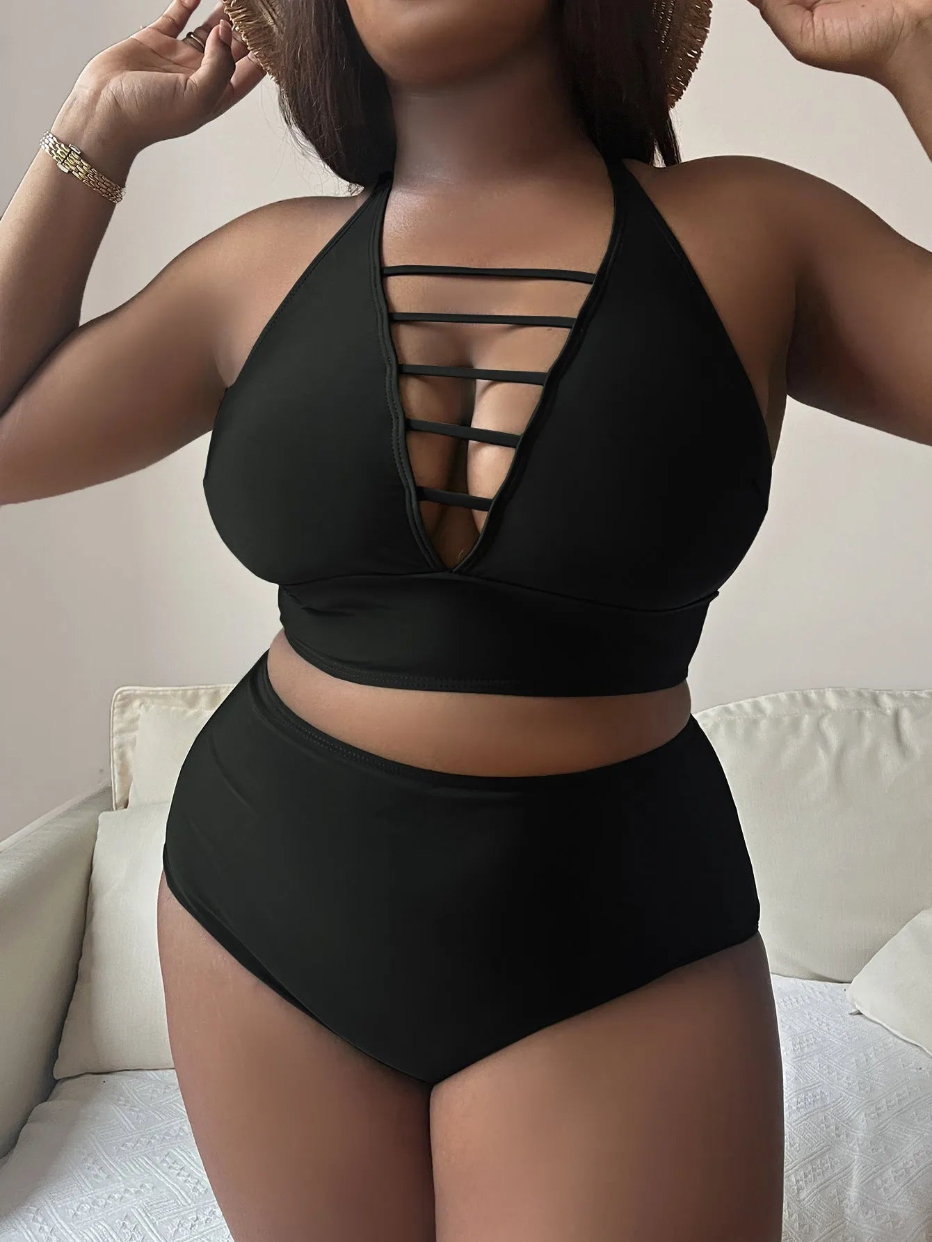 Plus size black halter bikini with cross back straps and high waist briefs on mannequin
