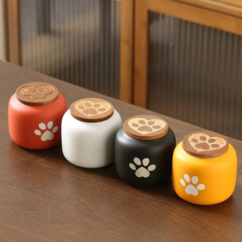 Ceramic pet funeral urn with foot print design in orange colour