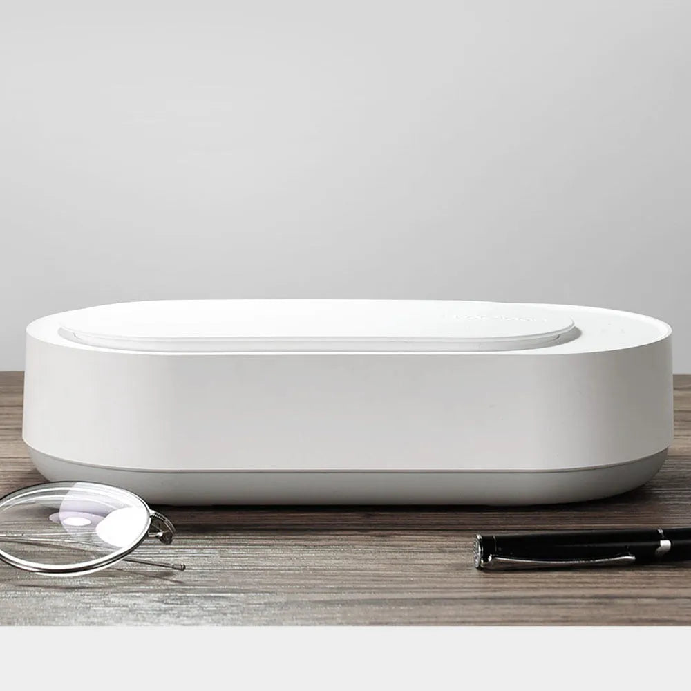 White portable ultrasonic cleaning machine with stainless steel tank and digital timer display.