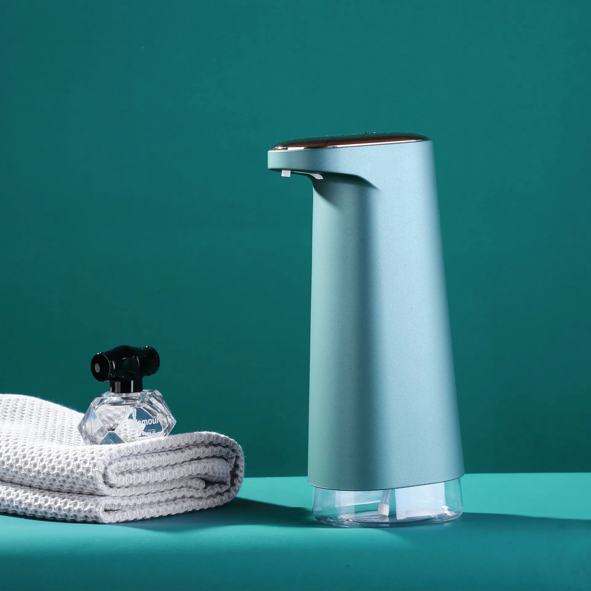 White automatic foam soap dispenser with infrared sensor for touch-free operation on a bathroom counter.