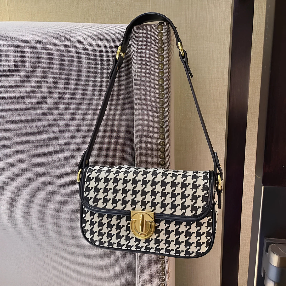 Women's houndstooth canvas baguette shoulder bag with adjustable strap on model