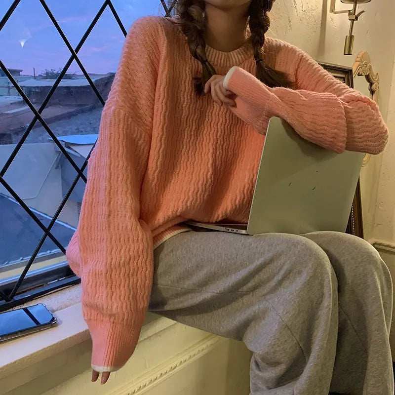 A woman's loose-fitting, solid-colour pullover sweater with regular sleeves, shown in lake blue.