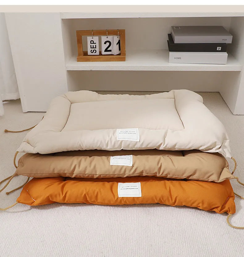 Beige tied cage cushion for small dog in crate showing secure attachment and warm bedding platform.