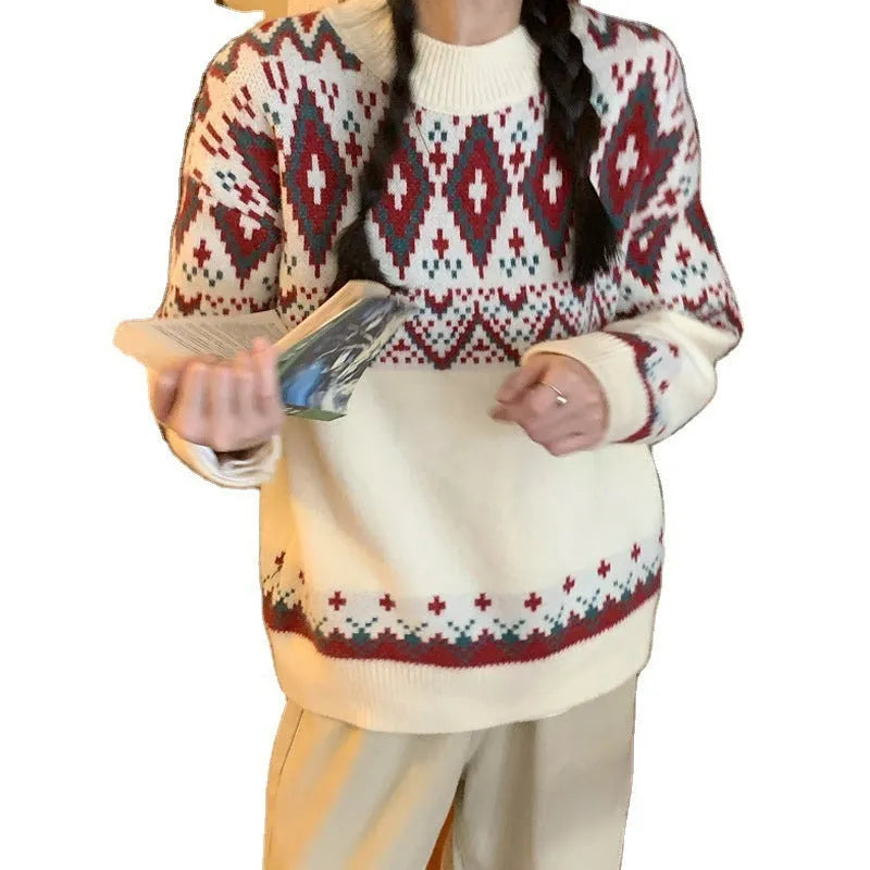 Red and white striped loose-fit knitted pullover with long sleeves on a model.