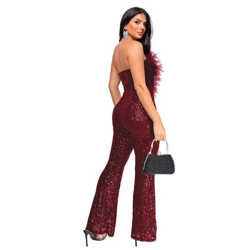 Women's black sleeveless backless jumpsuit with flared legs and sequin decoration.
