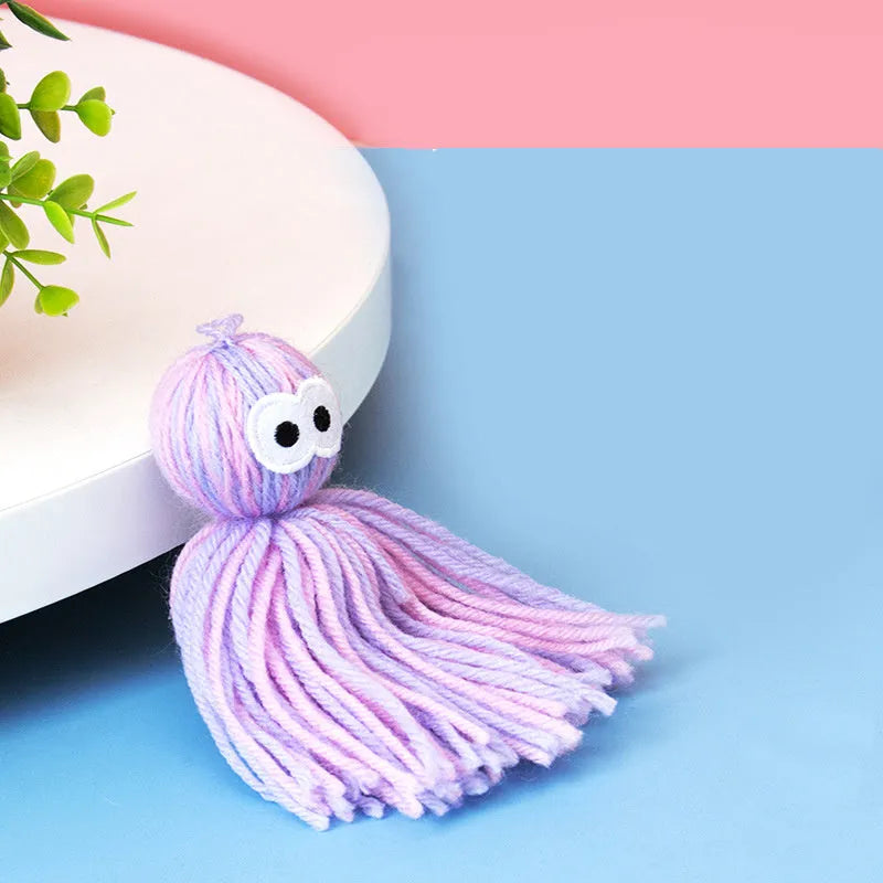 Wool cat ball toy with teaser stick attachment in blue-grey colour variation