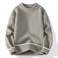 A man wearing a grey loose-fitting round neck casual pullover sweater.