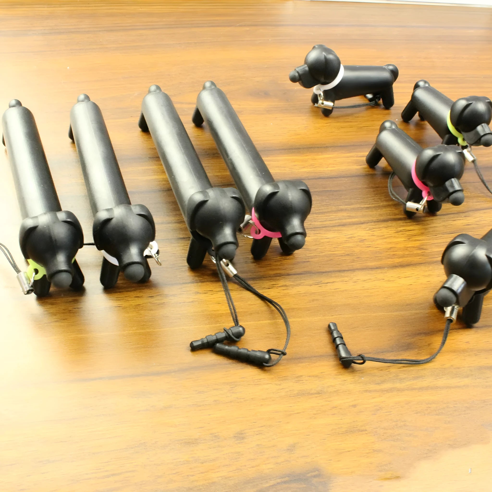 Black dog-shaped touch screen stylus shown with phone holder configuration