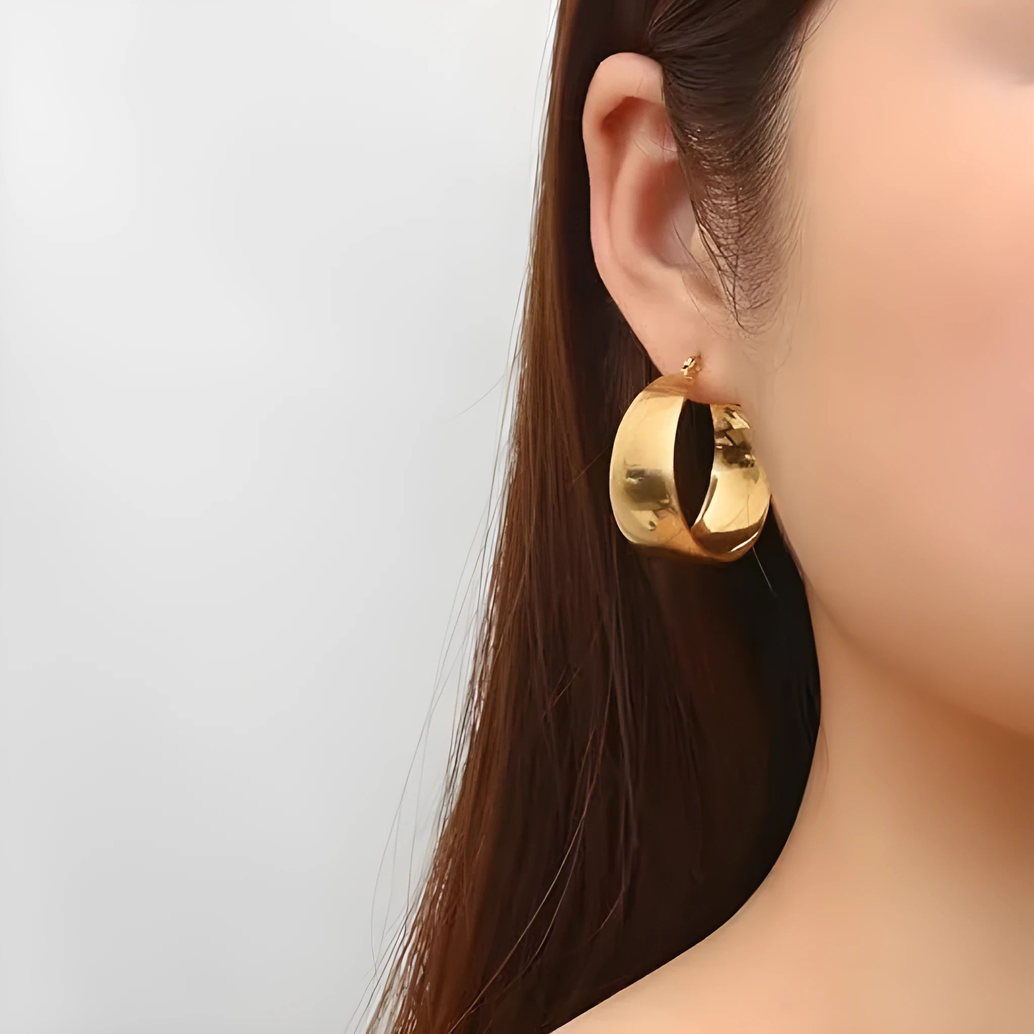 Widened curved stainless steel earrings with titanium construction in gold or steel colour, 25mm or 30mm diameter