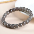 Natural Smokey Violet Hetian jade straight cut bracelet with geometric beads on a wrist.