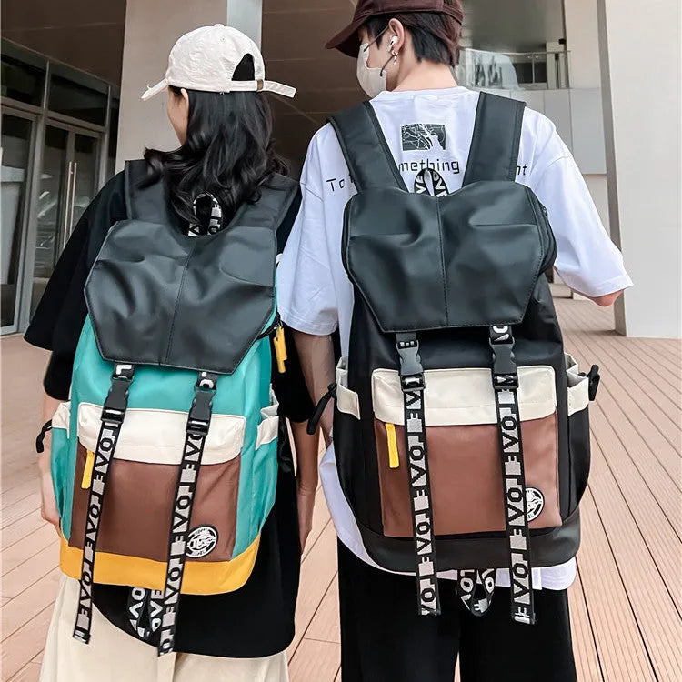 A mid-size black Oxford cloth backpack shown with handheld and two-shoulder carry options.