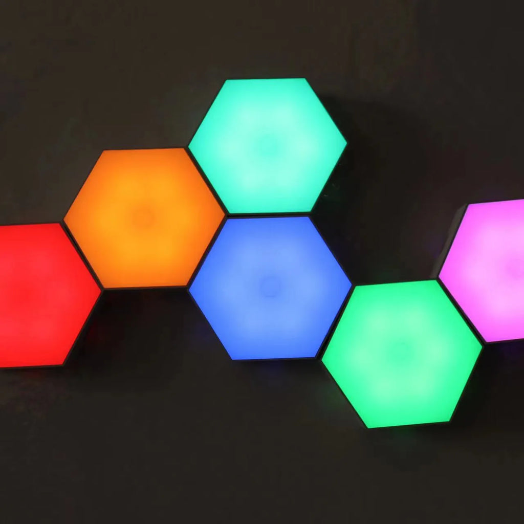 Close up of a modular hexagon LED wall light in a honeycomb pattern with multiple colour panels