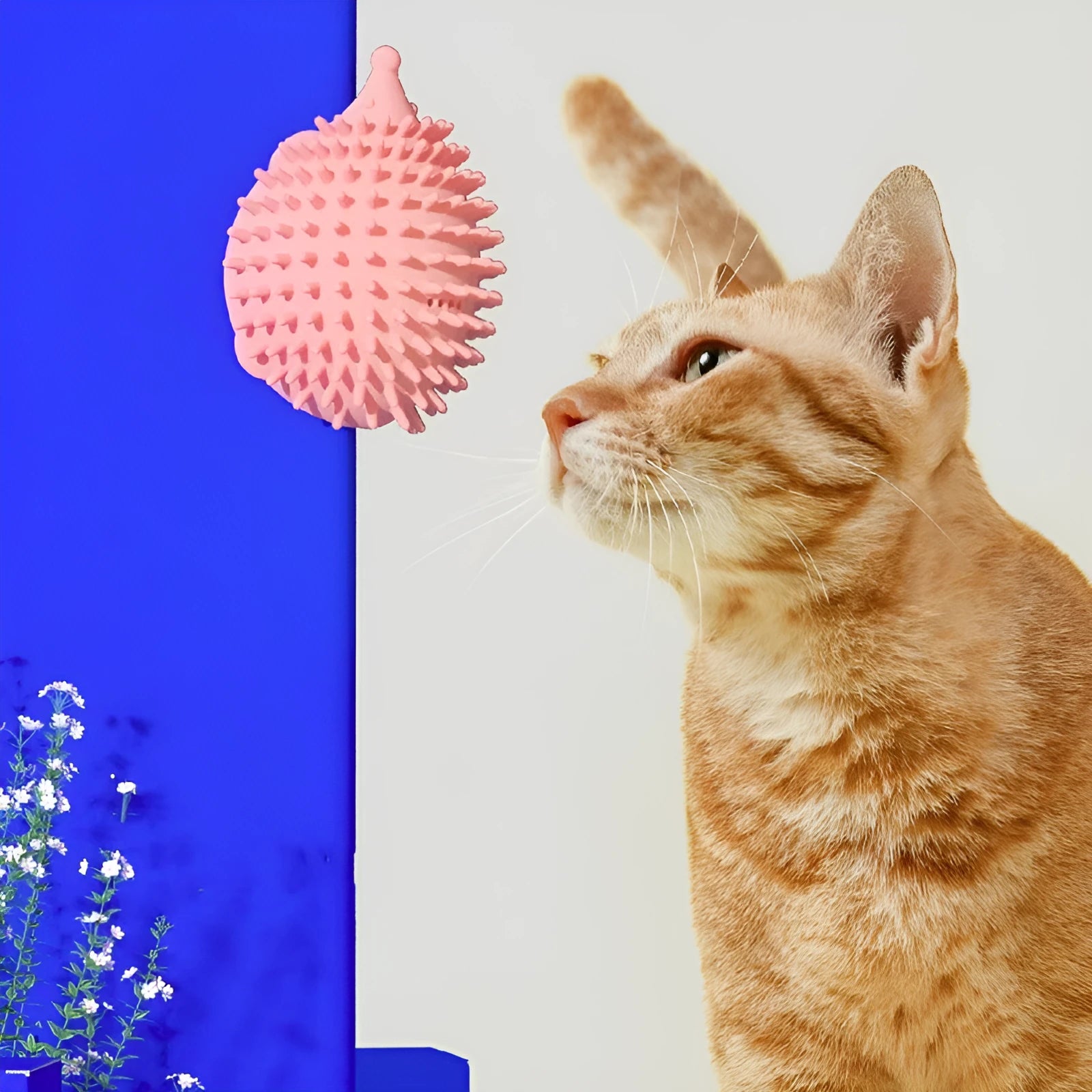 Green cat corner scratcher with plastic base and long teaser stick on a light background