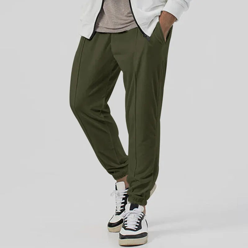 Men's grey straight-leg track sweatpants with a mid-waist, showcasing a relaxed fit and casual style.