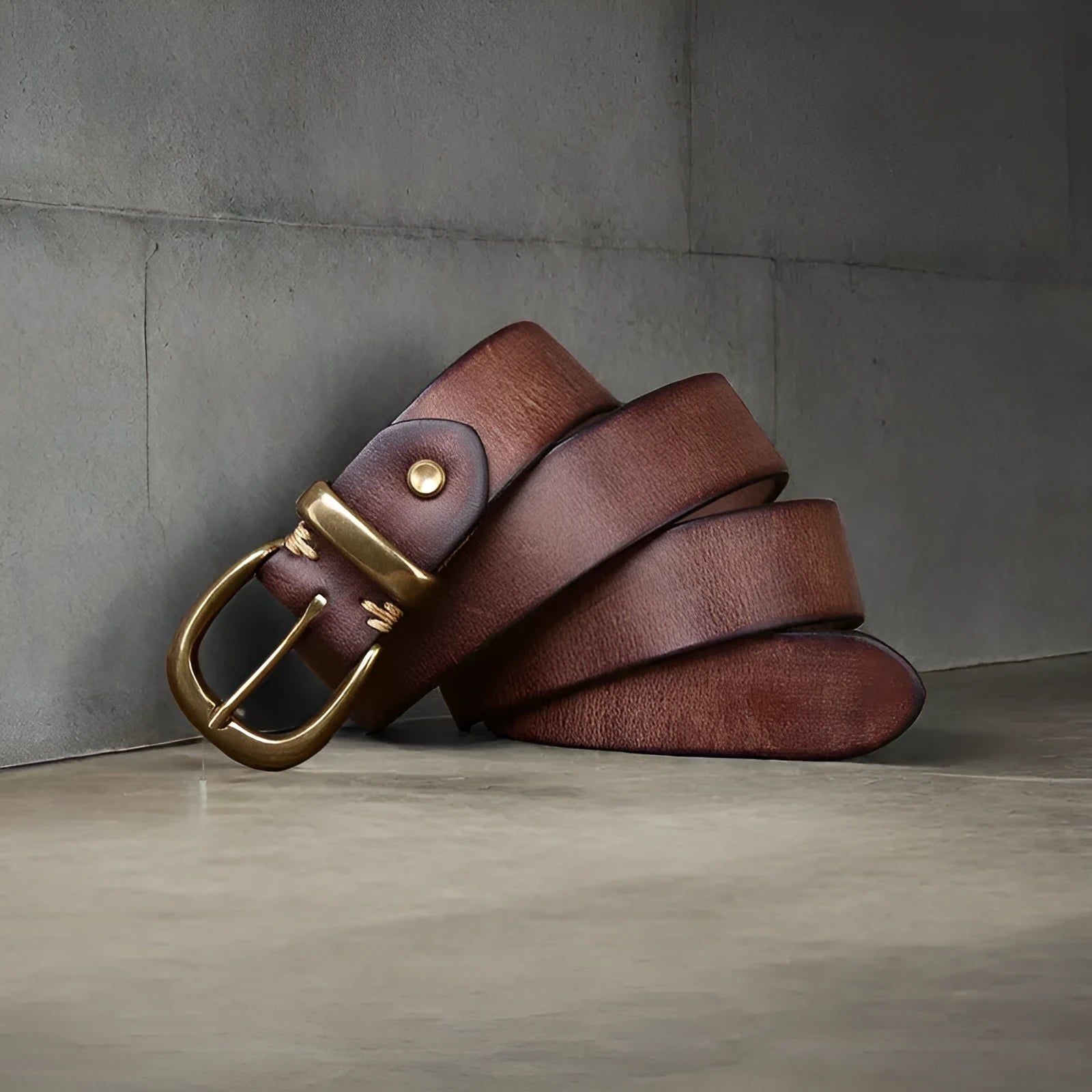 Men's black genuine leather casual belt with a copper pin buckle, showing length adjustment holes.