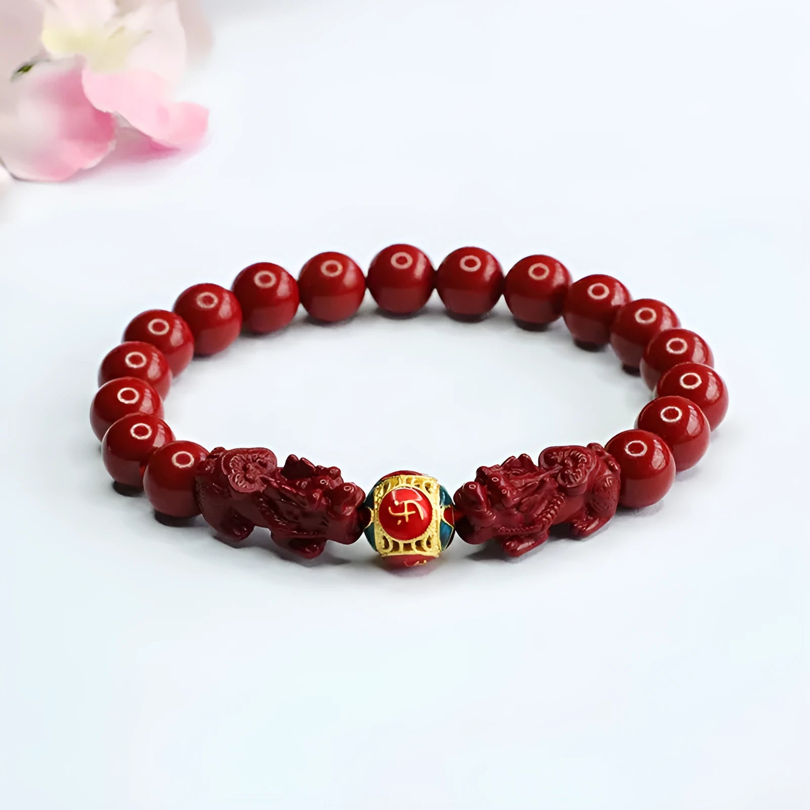 Close-up of a purple gold sand Cinnabar bracelet with carved Double Pixiu design, bead size 8mm.