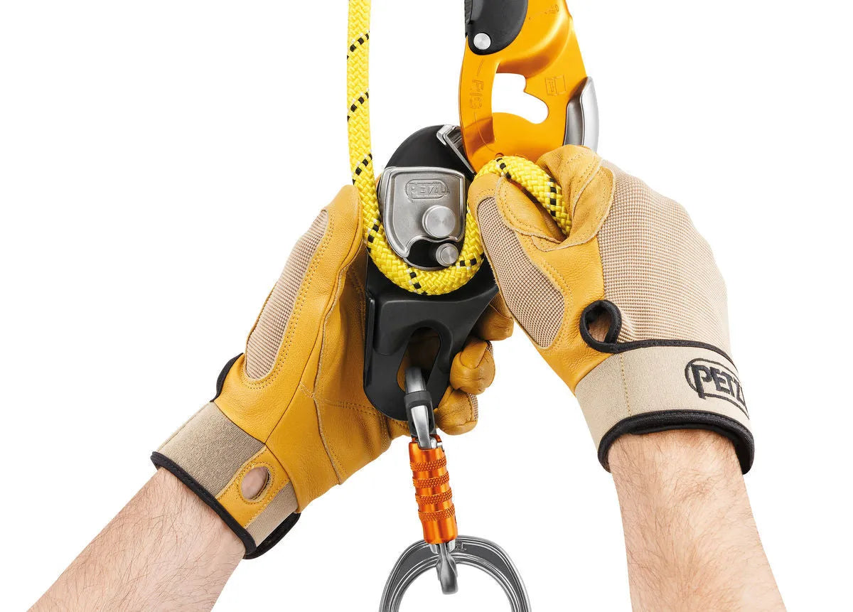 Petzl D021 RIG industrial rescue descender AUTO-LOCK black with rope installed and ergonomic handle visible