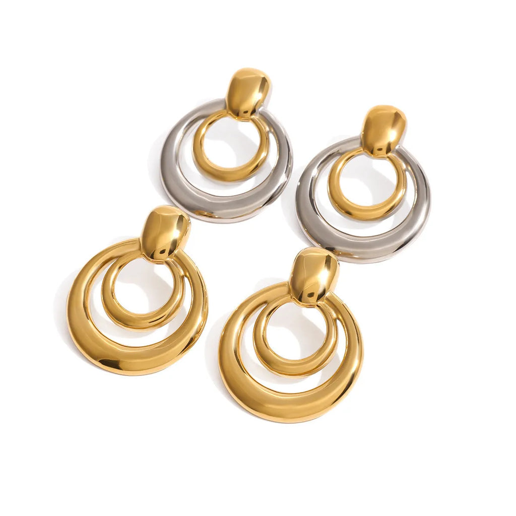 A pair of round, geometric double-layer hollow stud earrings with an 18K gold plated finish.