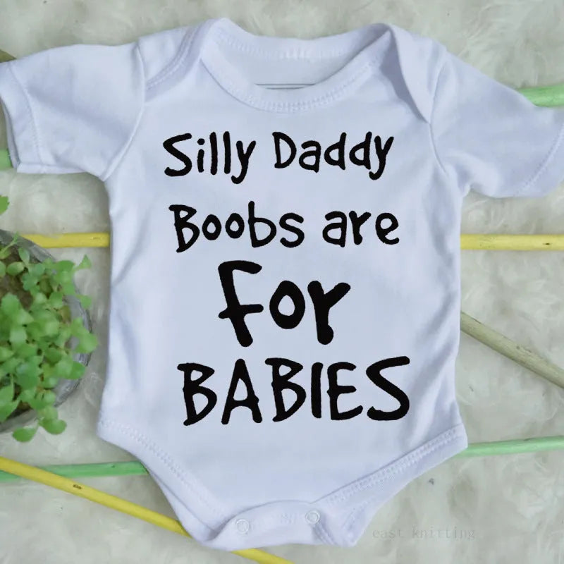 White triangle climbing vest top with printed text 'Silly Daddy Boobs Are For Babies' on the front