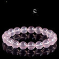 Natural pink starlight crystal round bead bracelet with polished 10mm stones on elastic cord