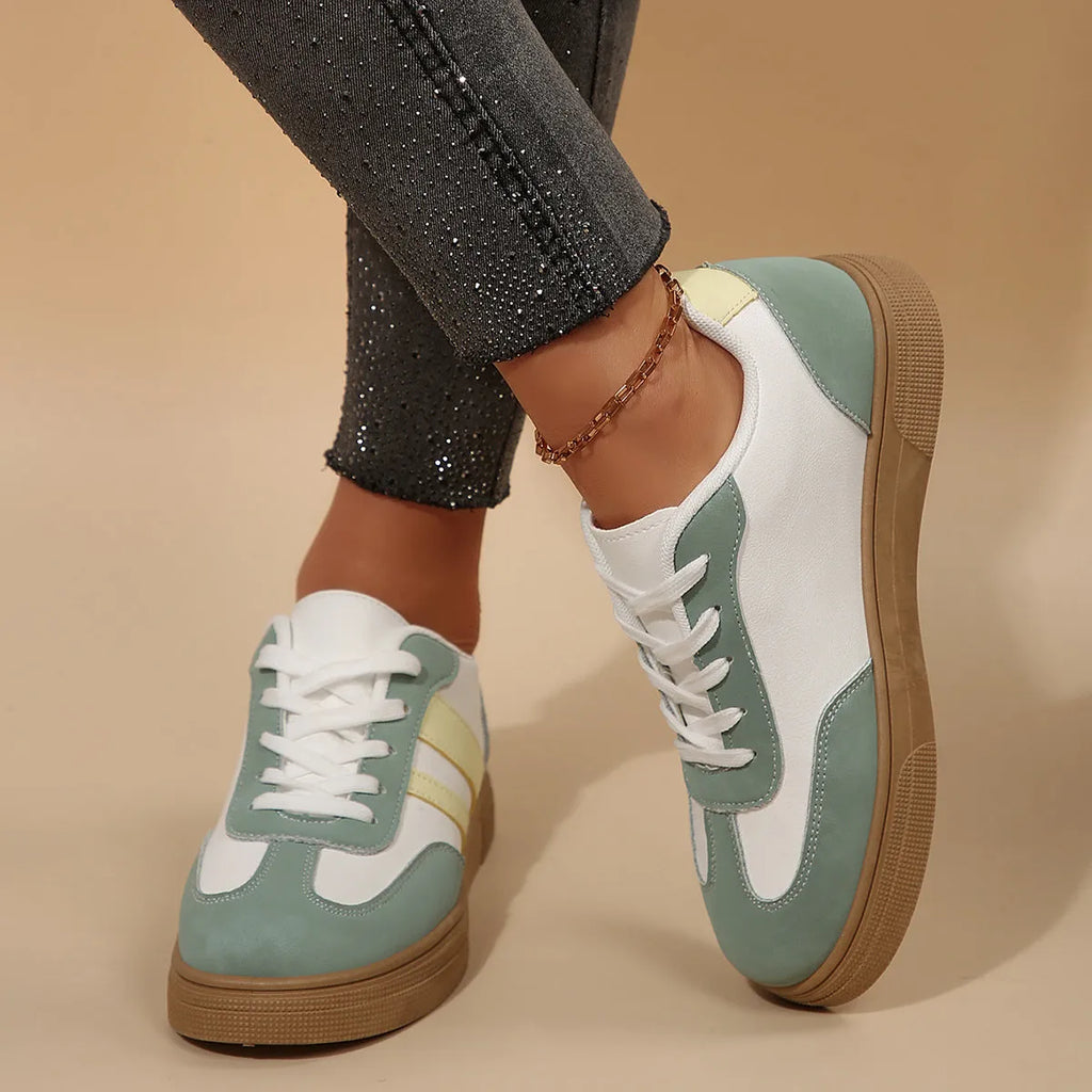 Green women's low-top retro sports shoes with cross straps and a flat rubber sole.