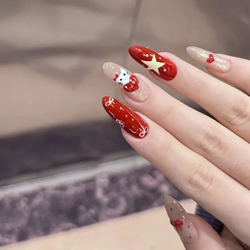 Assortment of sweet girl style false nails in various colours and designs, laid out on a table.