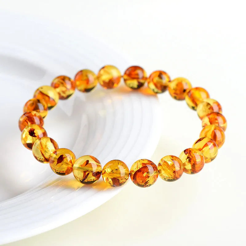 Natural yellow piebald amber bracelet with flower spot patterning and geometric design