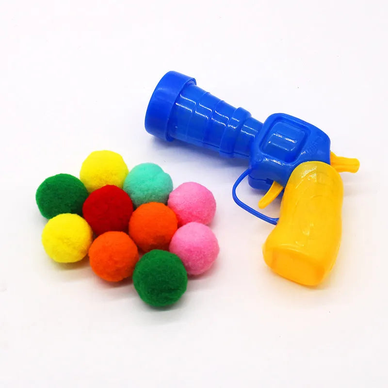 Plush pet toy gun with colourful yarn balls for interactive cat and dog play sessions