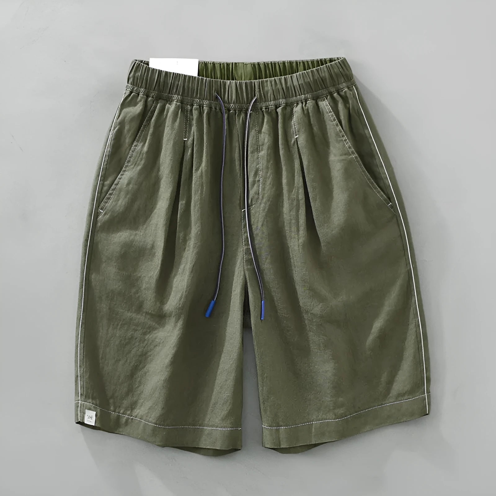 Men's loose straight leg linen shorts in green with drawstring waist and mid thigh length