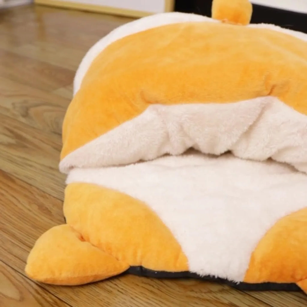 Orange semi-closed cat sleeping bag with plush texture, 65x53x12cm, on a wooden floor