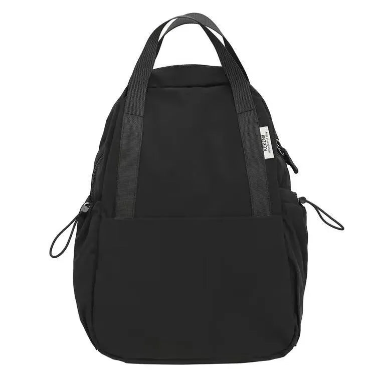 Simple solid colour nylon backpack in black on a neutral background, showing curved shoulder straps and top lock.