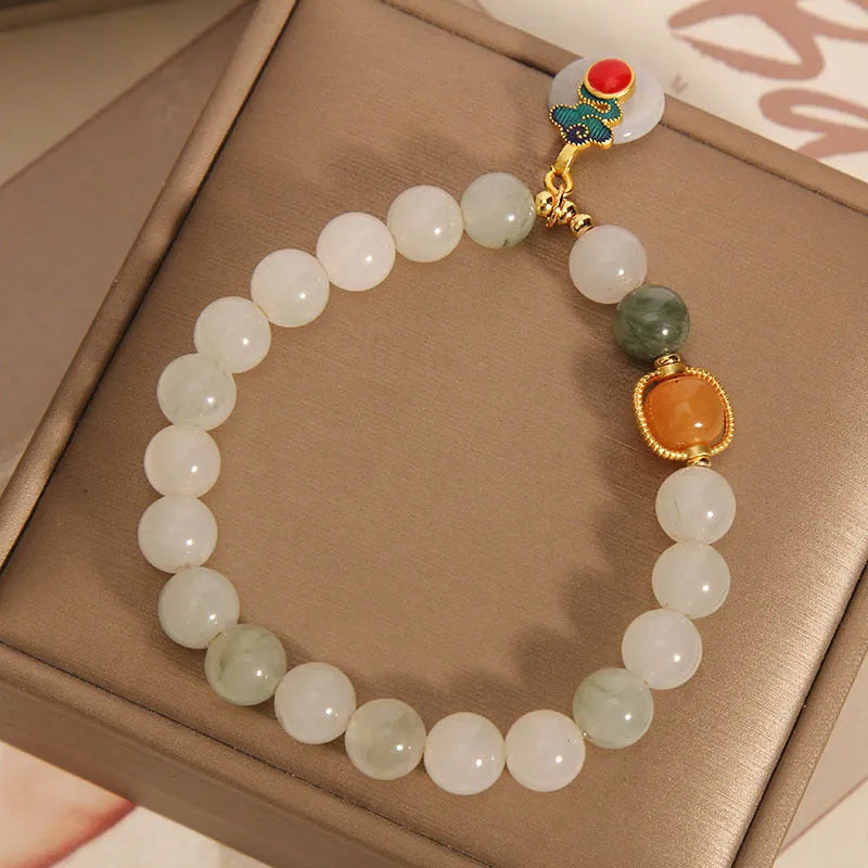Women's ice jade crystal bracelet with a pearl and a detailed Xiangyun peace jade buckle.