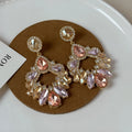 Pair of geometric rhinestone earrings with dot pattern on alloy base for women