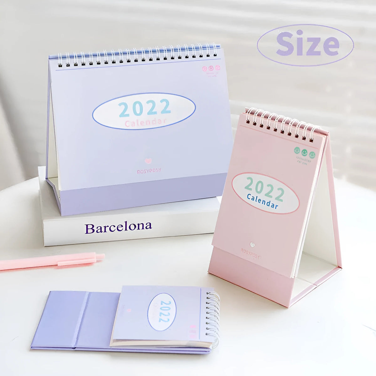 2022 paper desk calendar with coil binding, Regular or Professional size, in green, pink, purple, or yellow.